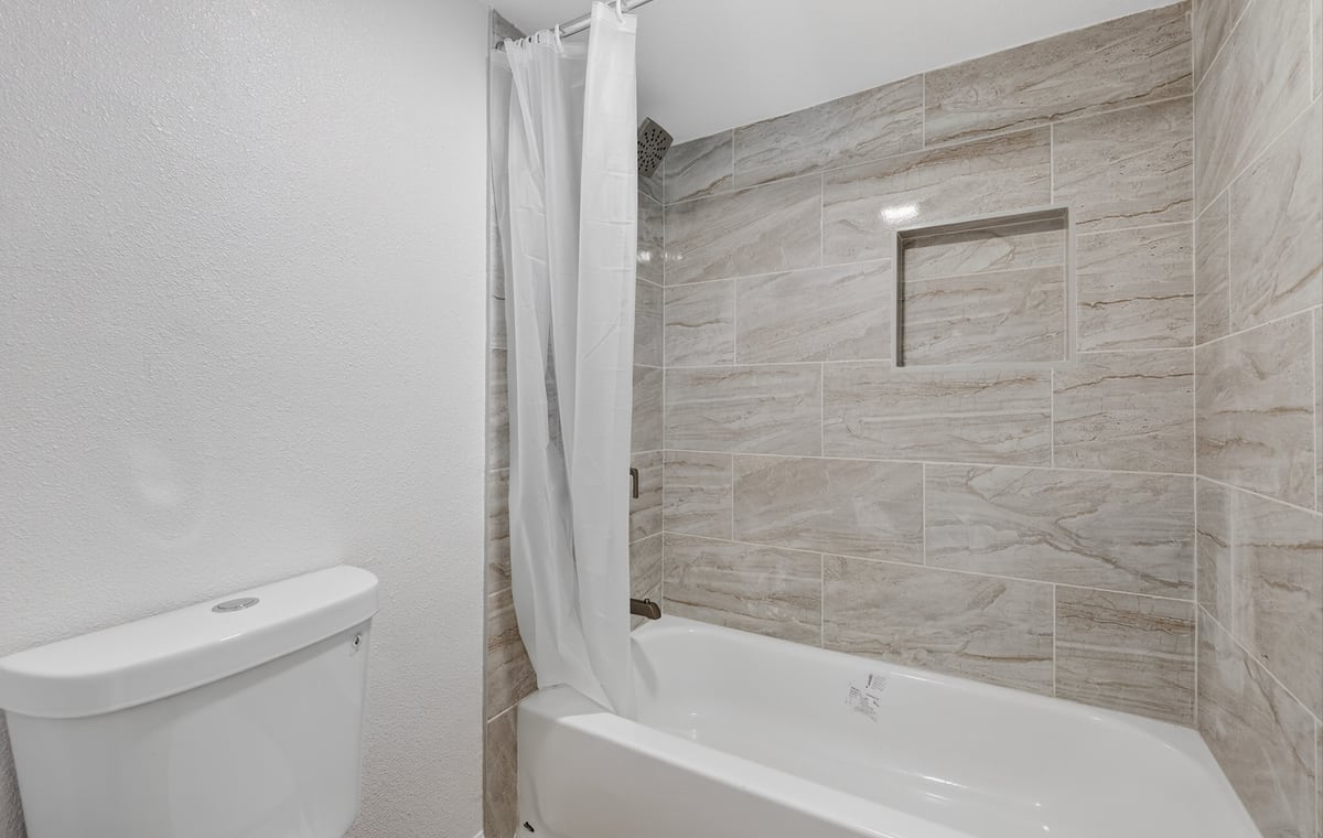 Updated bathroom with tile shower surround